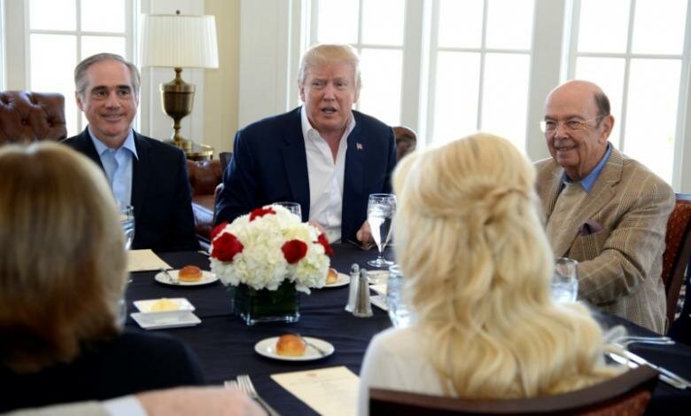 President Donald Trump makes remarks to the press as he sits down for a working lunch with members of his cabinet and their spouses, including Veteran's Administration Secretary David Shulkin (L) and Labor Secretary Wilbur Ross (R), at Trump National Golf Club, Potomac Falls,Virginia, in suburban Washington, U.S., March 11, 2017. REUTERS/Mike Theiler