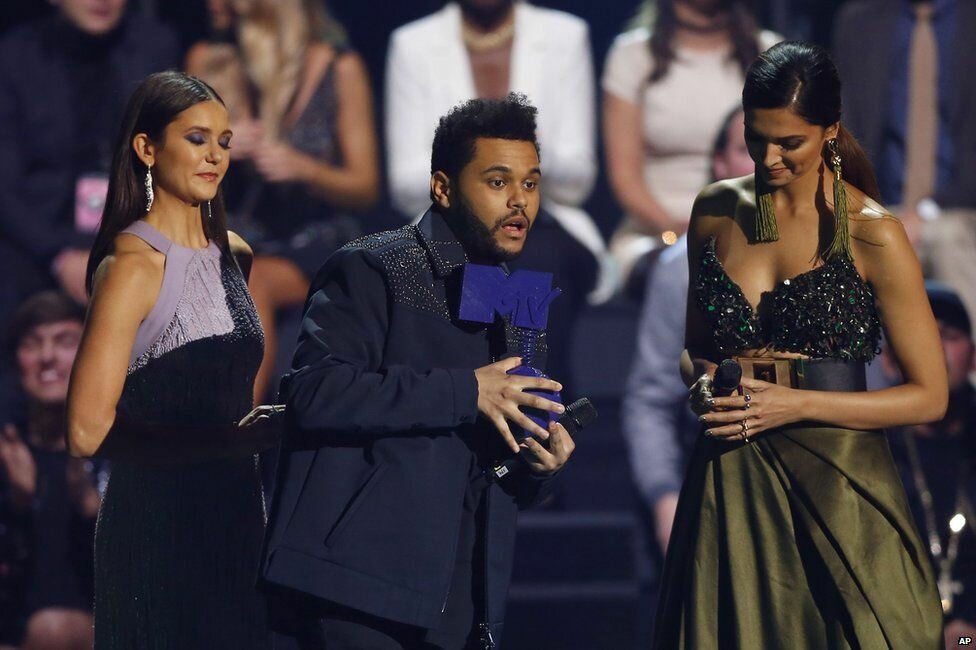 The Weeknd was handed his award by Nina Dobrev and Deepika Padukone
