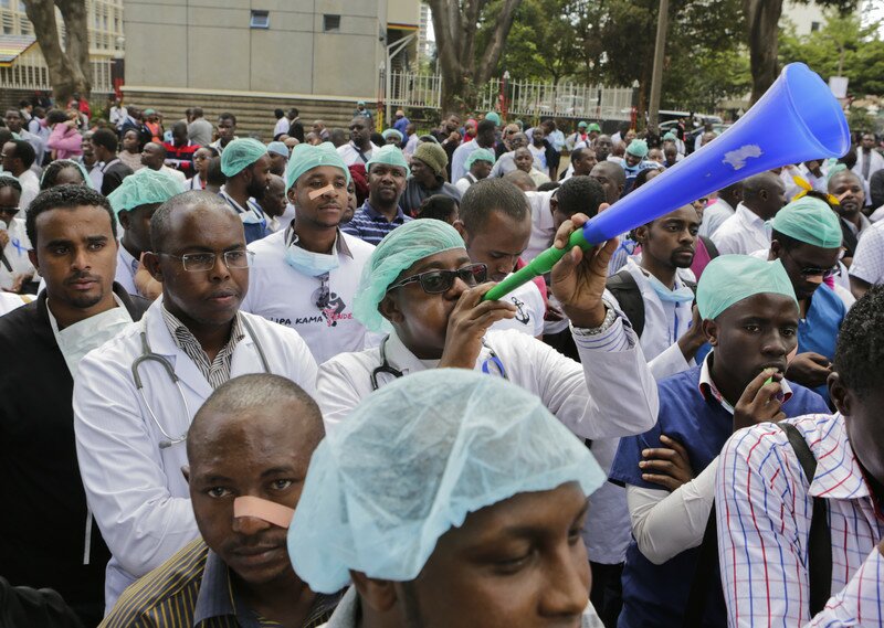 epa05661040 Kenyan health workers during a protest in Nairobi, Kenya, 05 December 2016. Thousands of health workers took to the streets in efforts to push the government to implement a Collective Bargaining Agreement (CBA) they signed in June 2013 to improve pay and conditions of work. Protesters demand a review of job groups, promotions, deployment and transfer of medical officers, as well as pay rise. According to local media, the country wide strike by nearly 5,000 doctors, nurses, pharmacists, dentists and interns is likely to affect at over 2,700 public health facilities including Kenyatta National Hospital and Moi Teaching and Referral Hospital in Eldoret, where most Kenyans seek emergency medical care. EPA/DANIEL IRUNGU