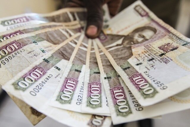 epa04333747 A man displays 1,000 Kenyan shillings notes in Nairobi, Kenya, 03 June 2014. EPA/DANIEL IRUNGU