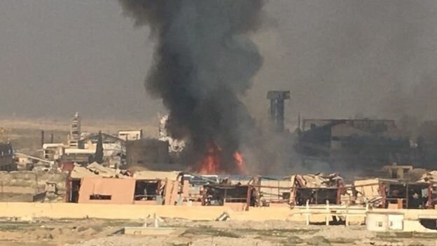 A sugar factory near the airport that had been held by IS is in flames
