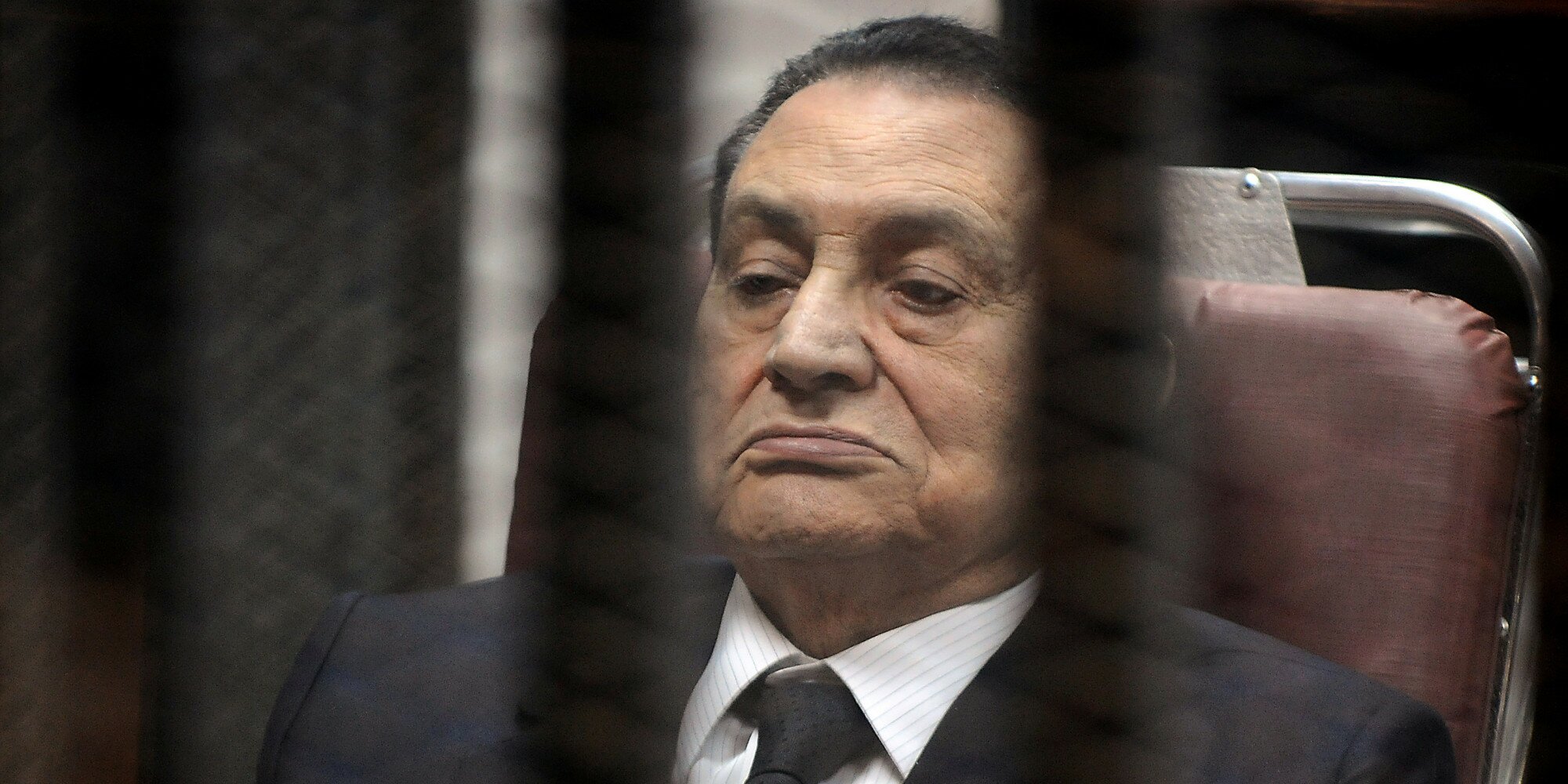 CAIRO, EGYPT - MARCH 19: Ousted Egyptian president Hosni Mubarek, in suit, appears in the trial about expenses for presidential palaces on March 19, 2014 in Cairo, Egypt. (Photo by Ahmed el Masry/Anadolu Agency/Getty Images)
