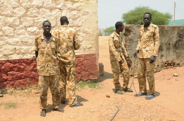 South Sudanese soldiers suspected of beating and raping civilians are chained together at the presidential guard unit, within the Sudan People's Liberation Army (SPLA) headquarters, after their arrest in the capital Juba, March 3, 2017. REUTERS/Jok Solomon